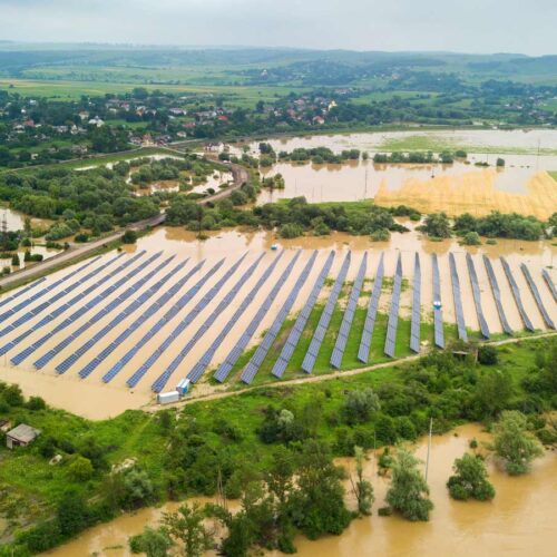 aerial view of flooded solar power station with dirty river water in rain season