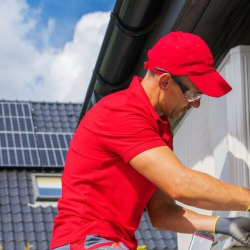 HVAC Worker Performing Heat Pump Maintenance. Device is Transferring Thermal Energy From the Outside Using the Refrigeration Cycle. Home Heating Technologies.