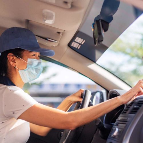 woman driving and using mobile device to navigate
