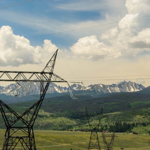 powerlines in front of a mountain range